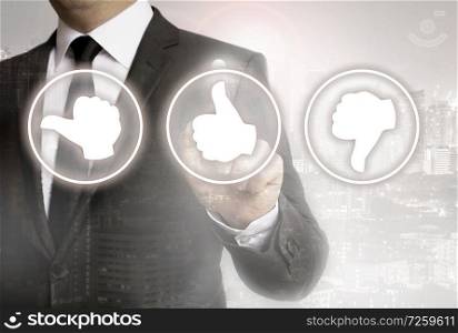 Businessman with city background showing customer appreciation icons.. Businessman with city background showing customer appreciation icons