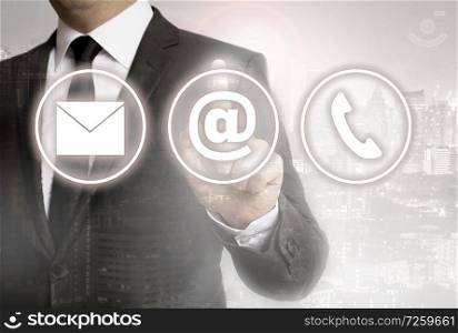 Businessman with city background shows contact options.. Businessman with city background shows contact options