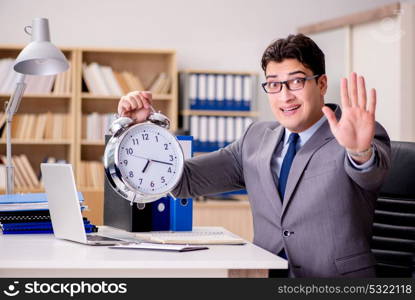 Businessman with clock failing to meet deadlines