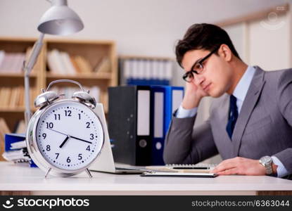 Businessman with clock failing to meet deadlines