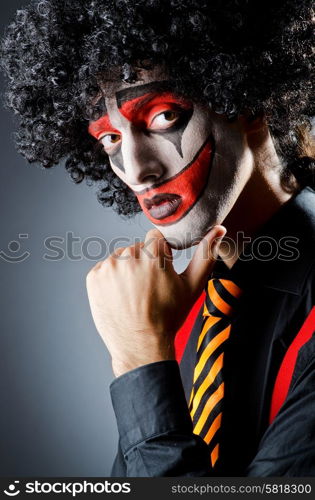 Businessman with clown wig and face paint