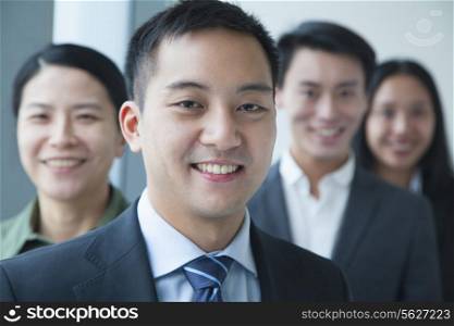 Businessman with co-workers in office portrait