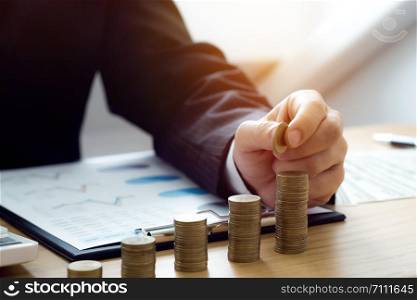 Businessman with coin stack, Financial concept.
