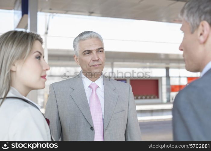 Businessman with colleagues on train platform