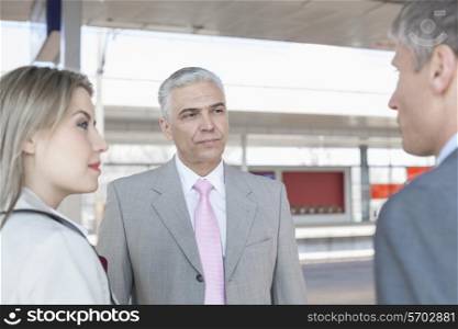 Businessman with colleagues on train platform
