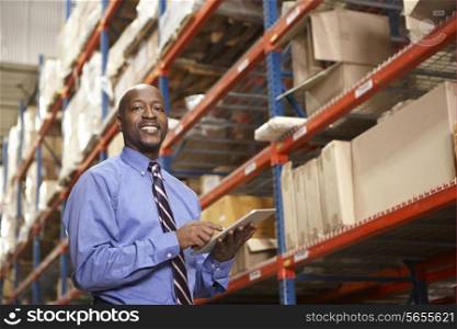 Businessman With Digital Tablet In Warehouse