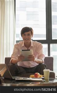 Businessman with digital tablet, portrait