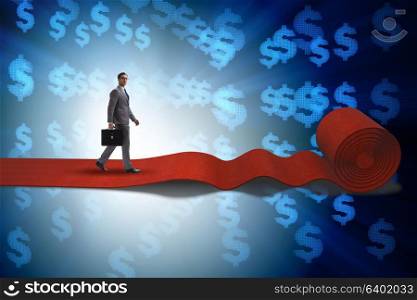 Businessman with dollars on red carpet