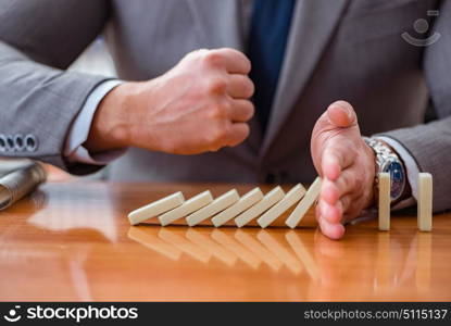 Businessman with dominoes in the office