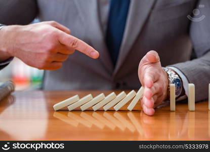 Businessman with dominoes in the office