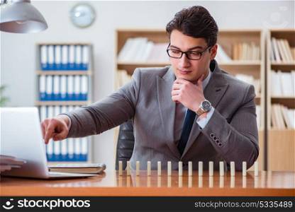 Businessman with dominoes in the office