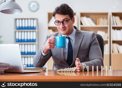 Businessman with dominoes in the office