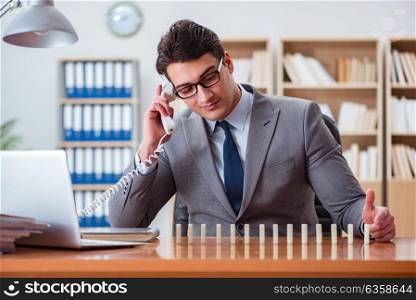 Businessman with dominoes in the office