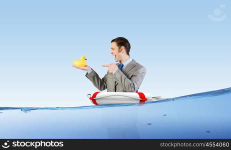 Businessman with duck. Funny businessman with yellow rubber duck toy