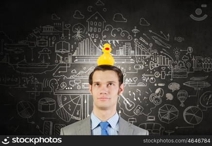 Businessman with duck. Funny businessman with yellow rubber duck toy