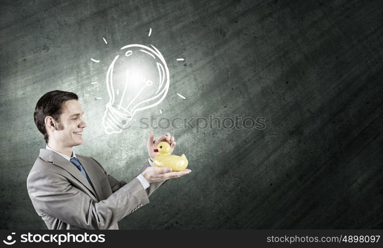 Businessman with duck. Funny businessman with yellow rubber duck toy