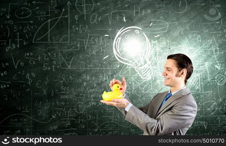 Businessman with duck. Funny businessman with yellow rubber duck toy