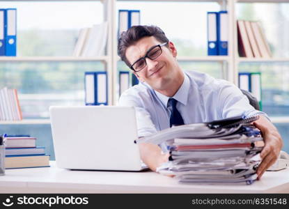 Businessman with excessive work paperwork working in office. The businessman with excessive work paperwork working in office