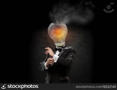 Businessman with exploded overworked lamp head on black background.