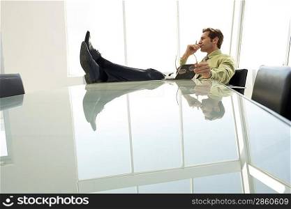 Businessman with feet up in conference room