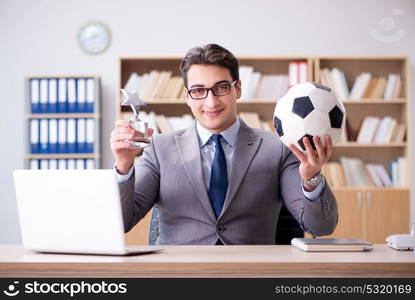 Businessman with football ball in office