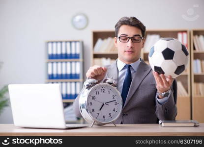 Businessman with football ball in office