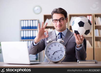 Businessman with football ball in office