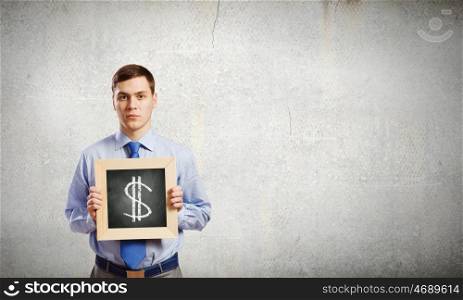 Businessman with frame. Young smiling businessman holding chalkboard with dollar sign