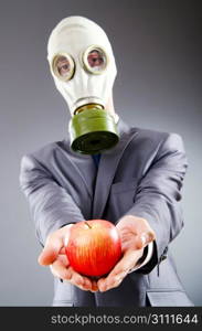 Businessman with gas mask and apple