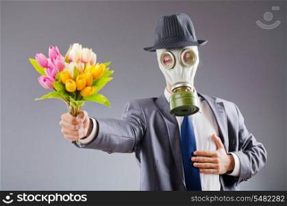 Businessman with gas mask and flowers