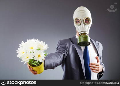 Businessman with gas mask and flowers