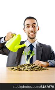Businessman with gold seedlings and coins
