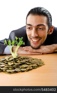 Businessman with gold seedlings and coins