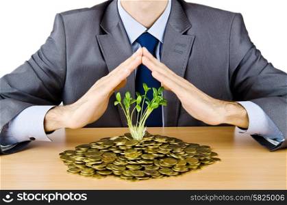 Businessman with gold seedlings and coins
