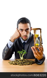 Businessman with gold seedlings and coins