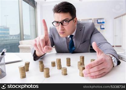 Businessman with golden coins in business growth concept