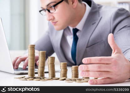 Businessman with golden coins in business growth concept