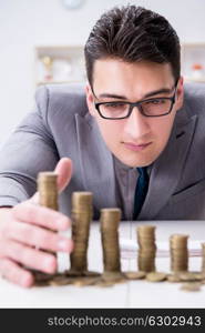 Businessman with golden coins in business growth concept