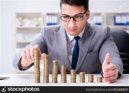 Businessman with golden coins in business growth concept. The businessman with golden coins in business growth concept