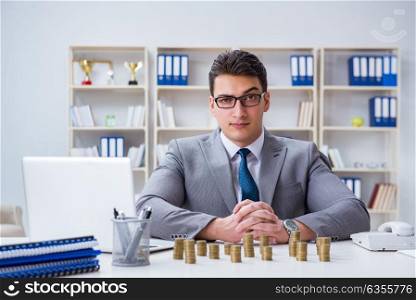 Businessman with golden coins in business growth concept