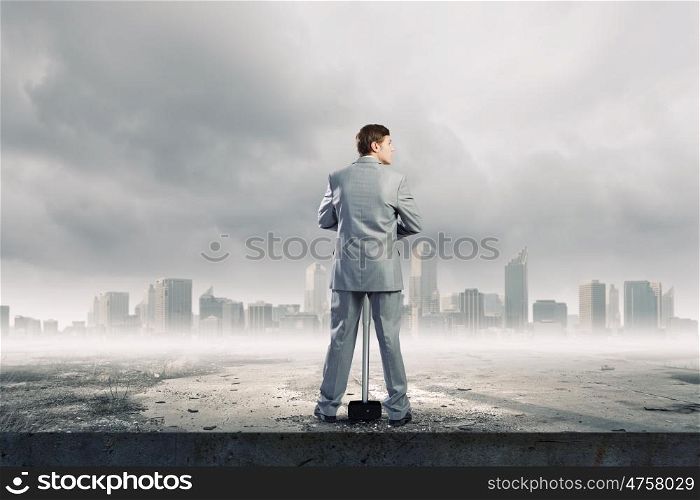 Businessman with hammer. Young determined businessman with big hammer in hands