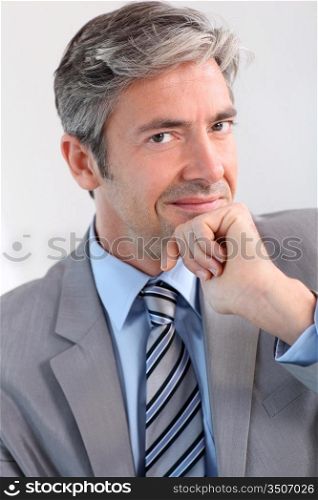Businessman with hand on chin