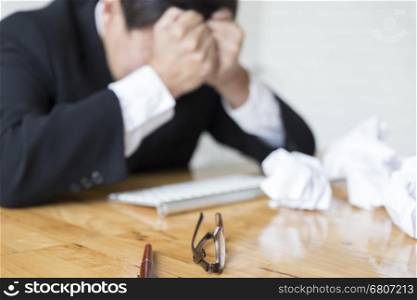businessman with hand on head in office - upset, frustrate, stress concept - blur for use as background