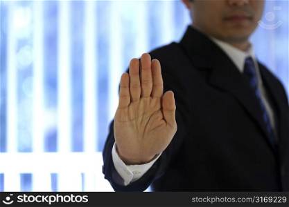 Businessman with hand raised