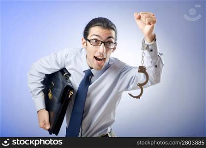 Businessman with handcuffs running away