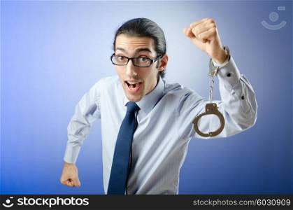 Businessman with handcuffs running away