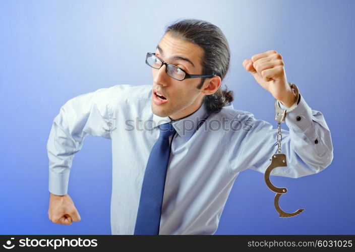 Businessman with handcuffs running away