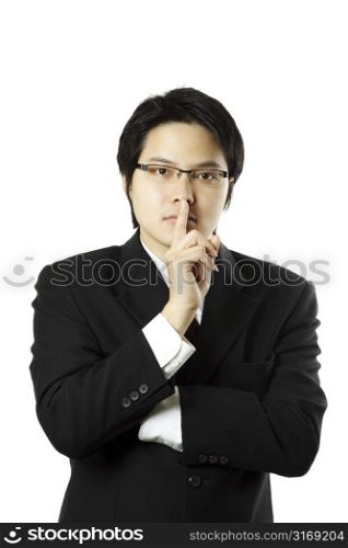 Businessman with his finger on his lips