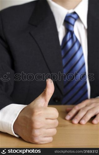 Businessman with his thumb up