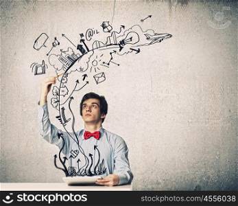 Businessman with ipad. Image of young businessman holding ipad against sketch background